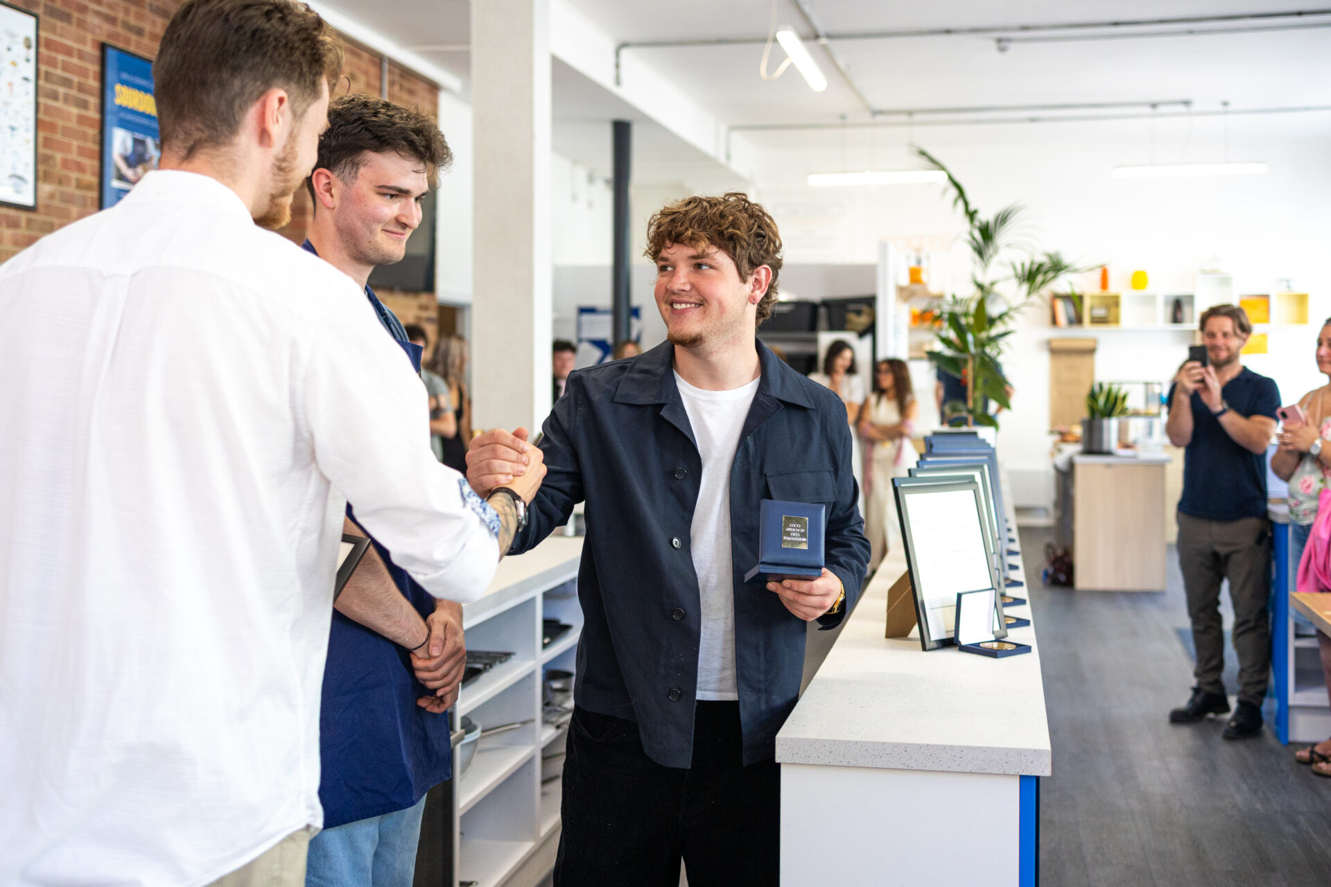 graduate receiving certificate and medal